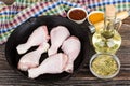 Chicken legs in frying pan, bottle of oil, tomato ketchup Royalty Free Stock Photo