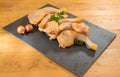 Chicken legs presented on a slate