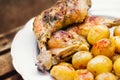 Chicken legs served with baby potatoes