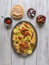 Chicken Mandi with dates on a wooden table. Arabic cuisine Royalty Free Stock Photo