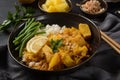 A Chicken Massaman Curry in black bowl at dark background Royalty Free Stock Photo