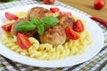 Chicken meat balls, pasta fusilli, tomatoes, basil on a white plate Royalty Free Stock Photo