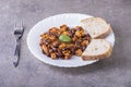 Chicken meat with beans sauce with bread on the plate on white Royalty Free Stock Photo