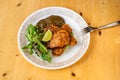 Chicken meat coating in garlic batter, aubergine sauce and fresh green salad leaf on plate Royalty Free Stock Photo