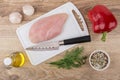 Chicken meat on cutting board, vegetable oil, sweet pepper, spic Royalty Free Stock Photo