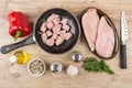 Chicken meat in dish and frying pan, spices, knife Royalty Free Stock Photo