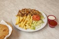 Chicken meat kebab menu with french fries, iceberg salad, tomato sauce, yogurt sauce and tomato sauce Royalty Free Stock Photo