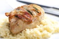 chicken meat on sage baked with bacon and served with couscous Royalty Free Stock Photo