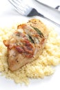 chicken meat on sage baked with bacon and served with couscous Royalty Free Stock Photo