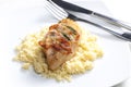 chicken meat on sage baked with bacon and served with couscous Royalty Free Stock Photo