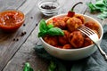 Chicken meatballs in a plate. Meatballs and basil. Copyspace. Wooden background