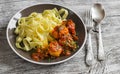 Chicken meatballs in tomato sauce and fettuccine pasta in a brown bowl Royalty Free Stock Photo