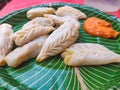 Chicken Momos with spicy chutni, viewed up close Stuffed filling dumplings