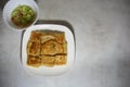 Chicken Murtabak is placed in a white plate. Chicken Murtabak is a very delicious Muslim food