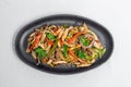 Chicken mushroom and capsicum stir fry recipe served on a sizzling plate.