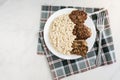 Chicken mushroom cutlets and pearl porridge on white plate on light background. Healthy dinner Royalty Free Stock Photo