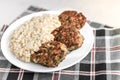 Chicken mushroom cutlets and pearl porridge on white plate on light background. Healthy dinner Royalty Free Stock Photo