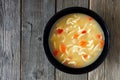 Chicken noodle soup, above view on rustic wood Royalty Free Stock Photo