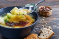 Chicken noodle soup and herbs in a plate on wooden boards, shallow depth of field, selective focus. The concept of