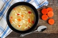 Chicken noodle soup, overhead scene on rustic wood Royalty Free Stock Photo