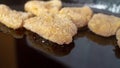 Chicken nuggets in breadcrumbs in a black cast-iron pan for baking Royalty Free Stock Photo