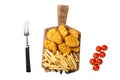 Chicken nuggets with ketchup and French fries on wooden board. Isolated on white background, top view. Royalty Free Stock Photo