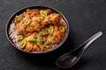 A Chicken Patiala in black bowl on dark slate table top. Murg Patiala is indian cuisine curry dish. Asian food and meal Royalty Free Stock Photo