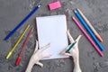 Chicken paw holds a pencil over a sheet of white paper for writing