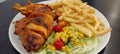 Chicken peri peri, chips with salad, delicious Royalty Free Stock Photo