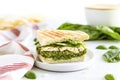 chicken pesto sandwich with toasted bread on a white cloth