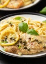 Chicken Piccata with capers, white wine sauce and spaghetti. Italian food Royalty Free Stock Photo