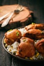 Chicken pieces baked in tomato sauce and boiled rice.