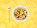 Chicken with pineapple in bowl with fork Royalty Free Stock Photo