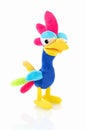 Chicken plushie doll isolated on white background with shadow reflection. Rainbow colored stuffed bird.
