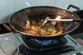 Chicken, pork in pan over the gas cooker