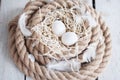 Easter, eggs, chicken eggs, quail eggs, eggs, rope, nest, white, feathers,in the hay Royalty Free Stock Photo