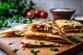 chicken quesadilla loaded with cheese, cheddar, cilantro and tomatoes, arranged in a circle on a board filled with veget Royalty Free Stock Photo