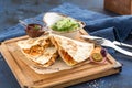 Chicken Quesadillas on Wooden Cutting Board on blue background Royalty Free Stock Photo