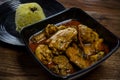 Chicken Rendang served with Nasi Minyak or butter rice isolated on wooden background Royalty Free Stock Photo