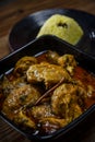 Chicken Rendang served with Nasi Minyak or butter rice isolated on wooden background Royalty Free Stock Photo