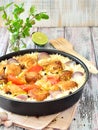 Chicken with rice and vegetables in a frying pan spices