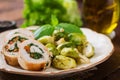 Chicken rolls with greens, garnished with stewed Brussels sprouts,