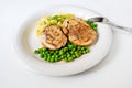 Chicken roulade, stewed pea and mashed potato on white plate Royalty Free Stock Photo