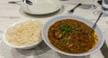 Chicken saag and rice on white plates