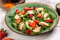 Chicken salad with arugula avocado and strawberries. Plate with a keto diet food. Top view Royalty Free Stock Photo