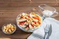 Chicken salad Caesar in transparent bowl, croutons and sauce caesar on the wooden home table. Homemade healthy food concept Royalty Free Stock Photo