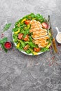 Chicken salad. Meat salad with fresh tomato, sweet pepper, arugula and grilled chicken breast. Chicken fillet with fresh vegetable Royalty Free Stock Photo