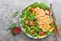 Chicken salad. Meat salad with fresh tomato, sweet pepper, arugula and grilled chicken breast. Chicken fillet with fresh vegetable Royalty Free Stock Photo