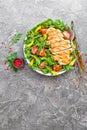 Chicken salad. Meat salad with fresh tomato, sweet pepper, arugula and grilled chicken breast. Chicken fillet with fresh vegetable Royalty Free Stock Photo