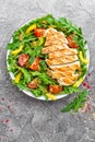 Chicken salad. Meat salad with fresh tomato, sweet pepper, arugula and grilled chicken breast. Chicken fillet with fresh vegetable Royalty Free Stock Photo